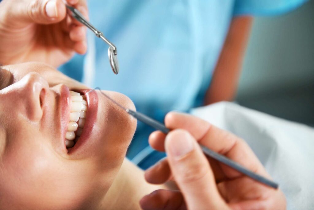 female patient getting her teeth looked at