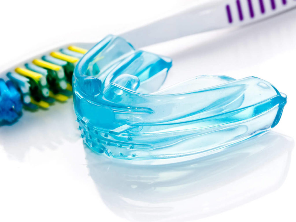 mouth guard and a tooth brush on a white background